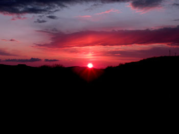 Silhouette of mountain against dramatic sky