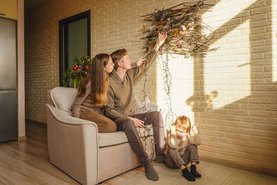 Mother and girl sitting at home