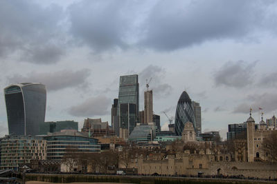 Cityscape against cloudy sky