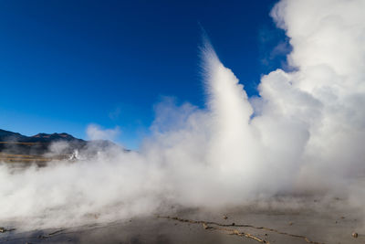 Water splashing against blue sky