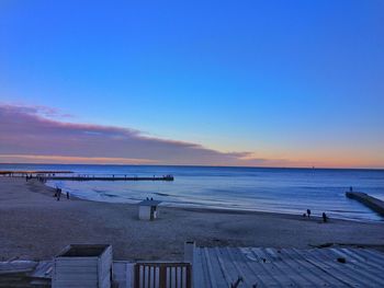 Scenic view of beach against sky during sunset