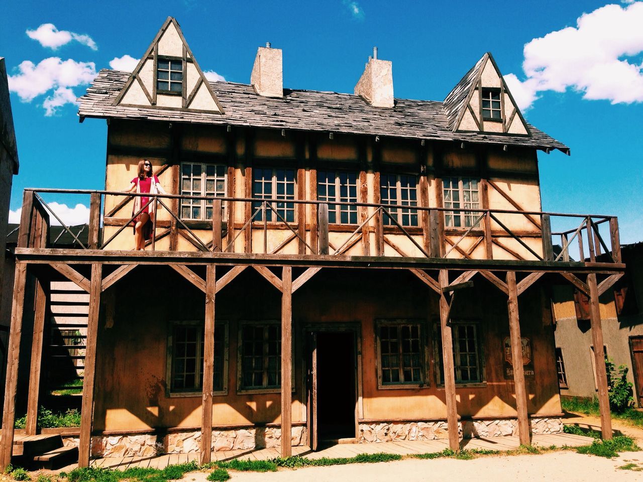 building exterior, architecture, built structure, low angle view, window, blue, facade, sky, house, exterior, sunlight, place of worship, residential structure, old, clear sky, residential building, outdoors, church, day, entrance