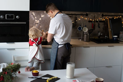 Man standing with ice cream at home
