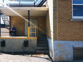 Man sitting outside building