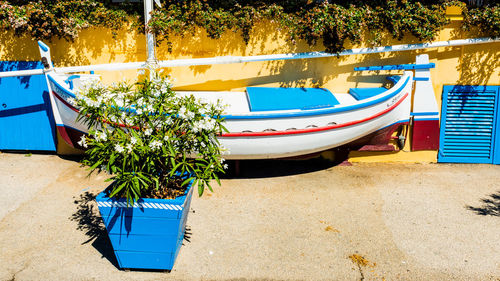 Boats moored by trees against plants