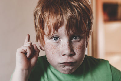 Close-up portrait of boy making face at home