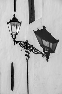 Low angle view of street light against wall