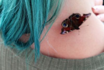 Close-up of woman with tattoo on shoulder