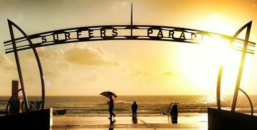 Pier on sea at sunset