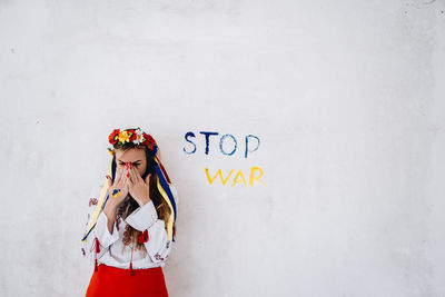 High angle view of woman standing against wall