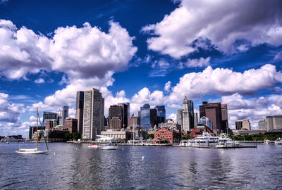 View of city at waterfront against sky