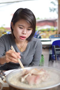 Portrait of woman holding ice cream in restaurant