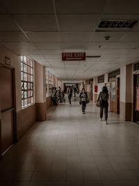 People walking in corridor of building
