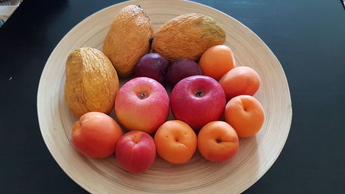 High angle view of fruits in plate at table