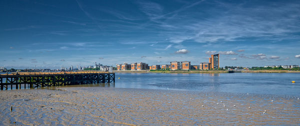 Calm sea with buildings in background