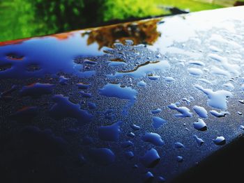 Close-up of water drops on blue surface
