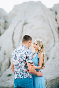 Happy couple standing on mountain