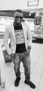 Portrait of young man standing in store