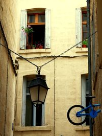 Low angle view of street light by building