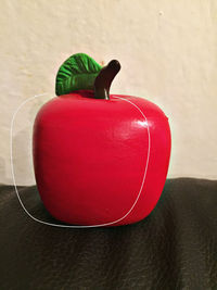 Close-up of red toy on table at home