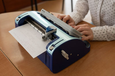 Midsection of man working on table