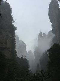 Scenic view of mountains against sky during foggy weather