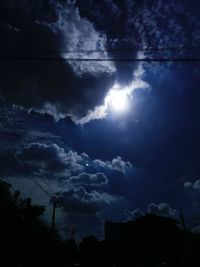 Low angle view of silhouette trees against sky