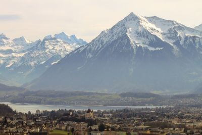 High angle view of townscape and mountains against sky