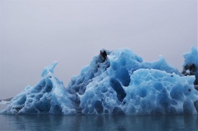 Snow on sea against sky