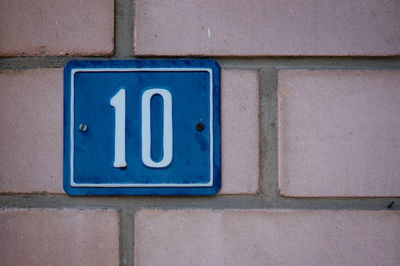 House number sign on brick wall