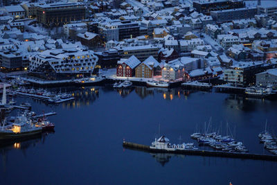 High angle view of boats moored at harbor in city