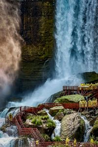 Scenic view of waterfall against sky at night