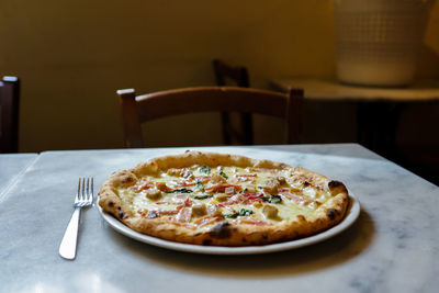 Close-up of pizza in plate on table