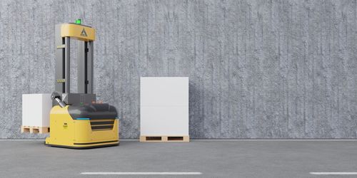 Close-up of yellow container on table against wall