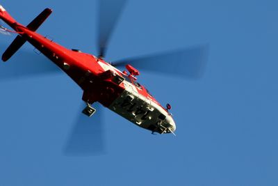 Low angle view of airplane against clear blue sky