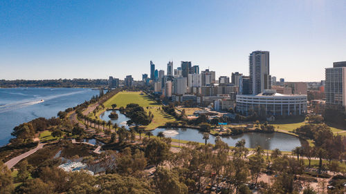 Buildings in city against clear sky