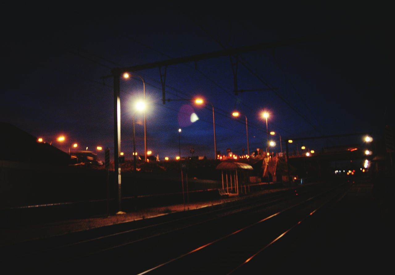 ILLUMINATED RAILROAD TRACKS AT NIGHT