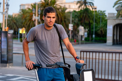 Young latin man with bicycle in the street