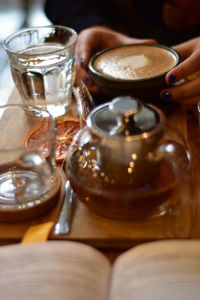 Moroccan tee and coffee on a wooden plate in a coffee shop with grape slice and books opened