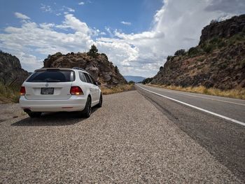 Cars on road against sky