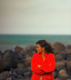 Close-up of woman standing on beach against sky