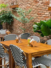 High angle view of empty chairs and tables and table by wall