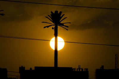 Low angle view of silhouette city against sky during sunset