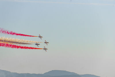 Low angle view of airplane flying against sky