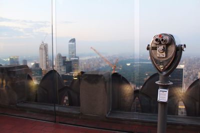 View of city lit up against sky