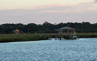 Scenic view of river against cloudy sky