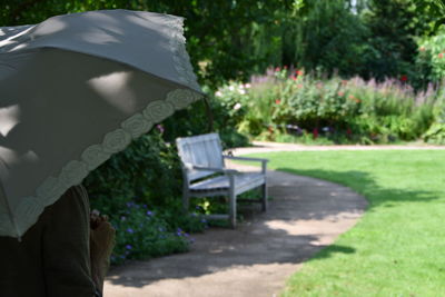 Man holding bench in park during rainy season