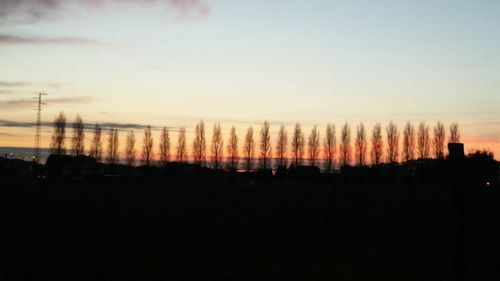 Silhouette landscape against sky during sunset