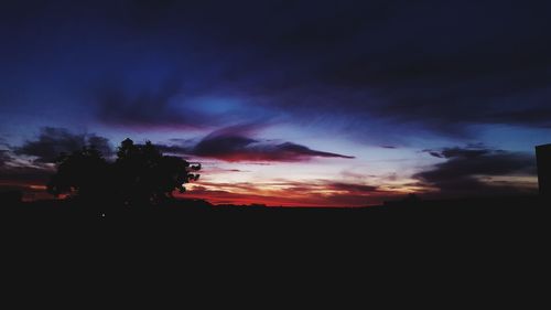 Scenic view of silhouette landscape against sky at sunset