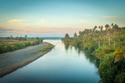 Scenic view of river against sky during sunset